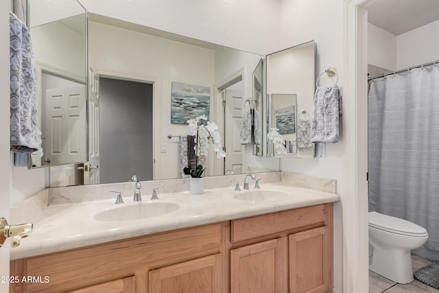 full bathroom with tile patterned floors, a sink, toilet, and double vanity