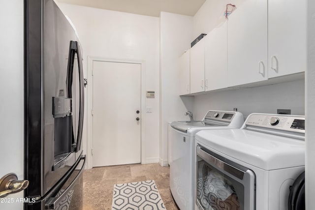 washroom featuring cabinet space and washer and dryer