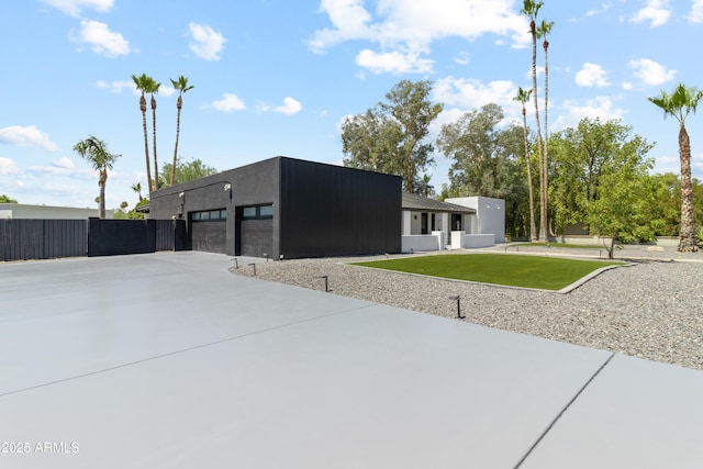 view of front of home with a front lawn and a garage