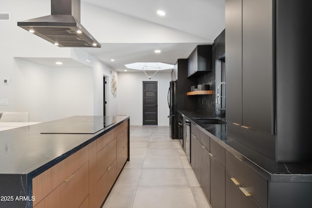 kitchen with a large island, black appliances, island exhaust hood, light tile patterned floors, and sink