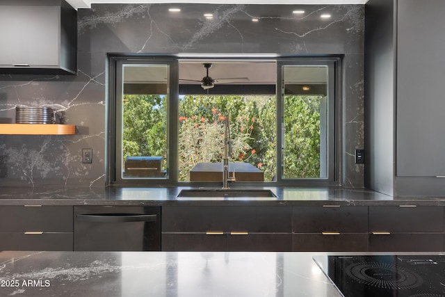 kitchen with sink, black appliances, tasteful backsplash, and a wealth of natural light