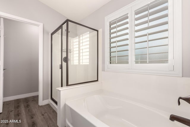 4142 E Sandy Way, Gilbert, AZ 85297 - bathroom with a stall shower, a garden tub, wood finished floors, and baseboards