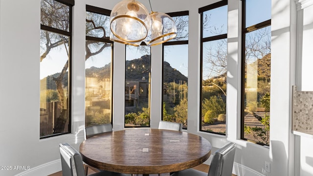 sunroom featuring a notable chandelier