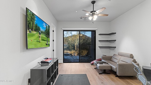 living room featuring ceiling fan and light hardwood / wood-style flooring