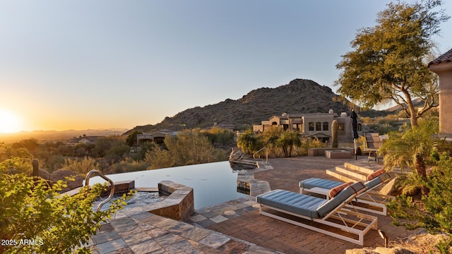 patio terrace at dusk with a mountain view