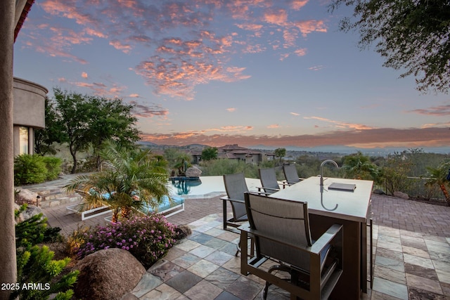 patio terrace at dusk with a mountain view