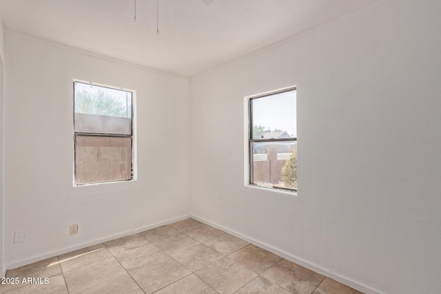 2562 E Wier Ave, Phoenix, AZ 85040 - unfurnished room featuring baseboards and light tile patterned floors