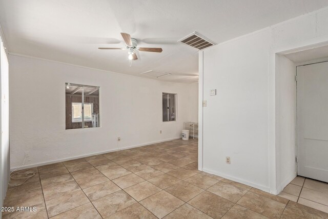 2562 E Wier Ave, Phoenix, AZ 85040 - spare room with attic access, ceiling fan, light tile patterned floors, and baseboards