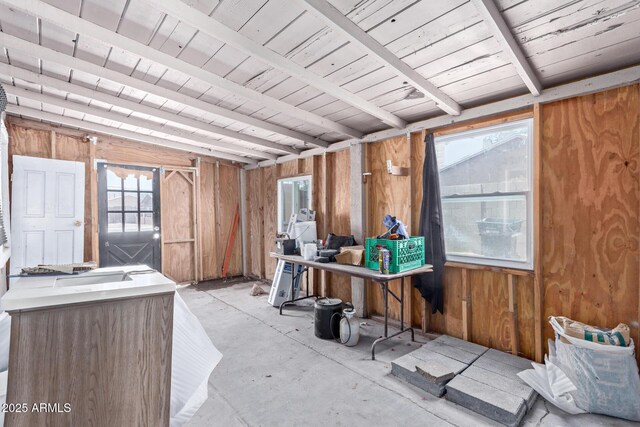 2562 E Wier Ave, Phoenix, AZ 85040 - miscellaneous room featuring wood walls and concrete flooring