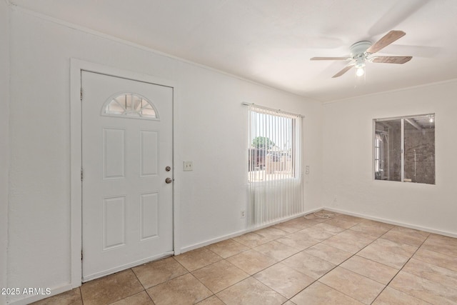2562 E Wier Ave, Phoenix, AZ 85040 - foyer with ceiling fan, ornamental molding, light tile patterned floors, and baseboards