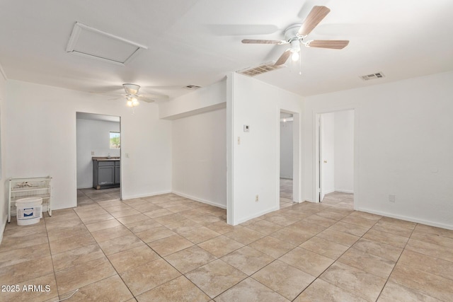 2562 E Wier Ave, Phoenix, AZ 85040 - unfurnished room with ceiling fan, light tile patterned flooring, and attic access