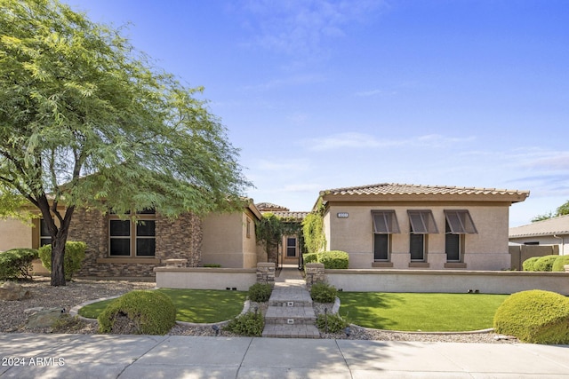 mediterranean / spanish-style house featuring a front lawn