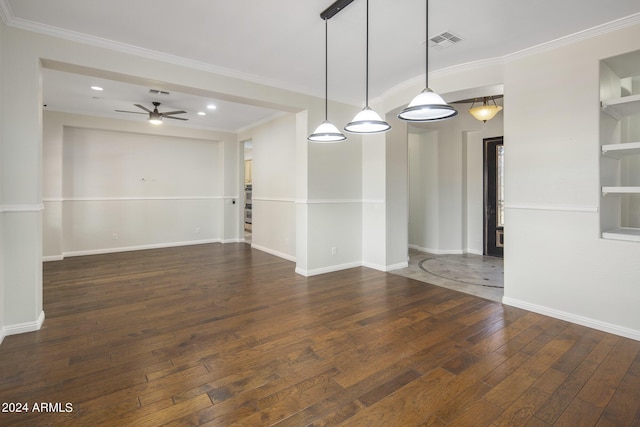 spare room featuring ornamental molding, dark wood-type flooring, built in features, and ceiling fan