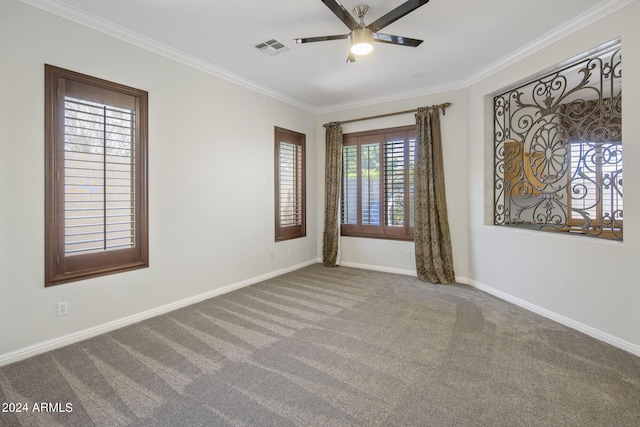 empty room featuring crown molding, carpet floors, and ceiling fan