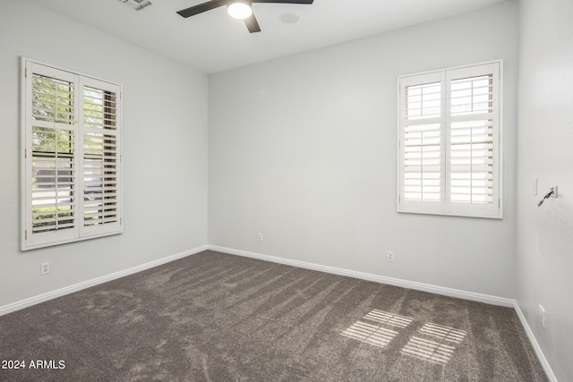 carpeted empty room featuring ceiling fan