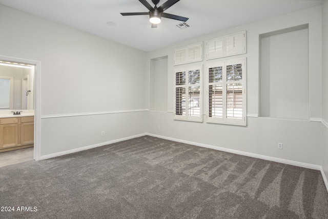 carpeted spare room with sink and ceiling fan