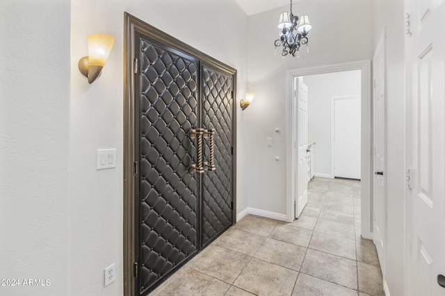 foyer with a chandelier and light tile patterned flooring