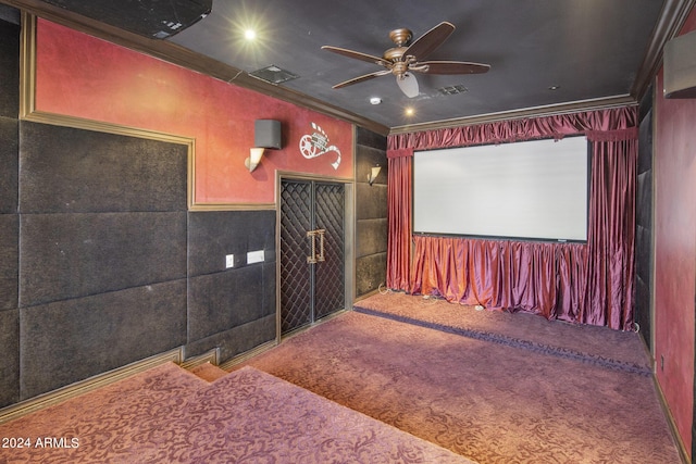 home theater featuring ornamental molding, ceiling fan, and carpet