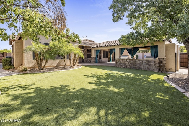 back of property featuring a yard and a patio area