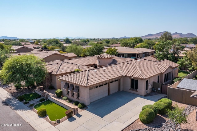 birds eye view of property featuring a mountain view