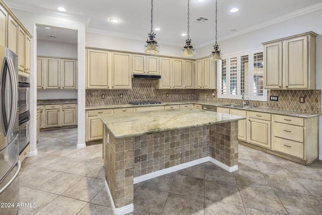 kitchen with sink, light stone counters, crown molding, decorative light fixtures, and a kitchen island