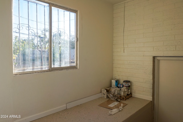 interior space featuring brick wall