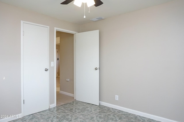 unfurnished room featuring ceiling fan and light tile patterned floors