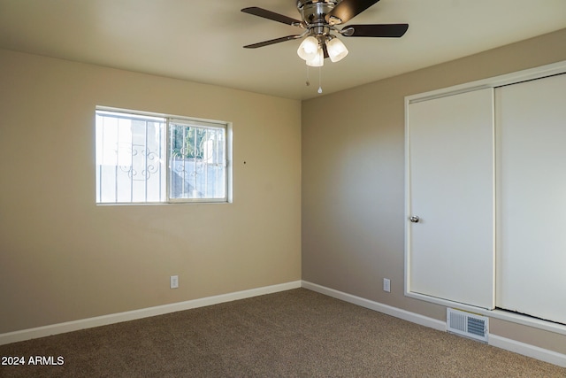 unfurnished bedroom with a closet, carpet, and ceiling fan