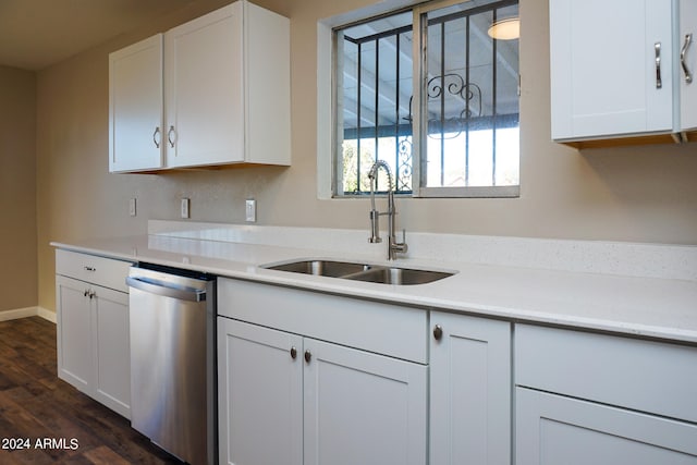 kitchen with white cabinets, stainless steel dishwasher, sink, and dark hardwood / wood-style flooring