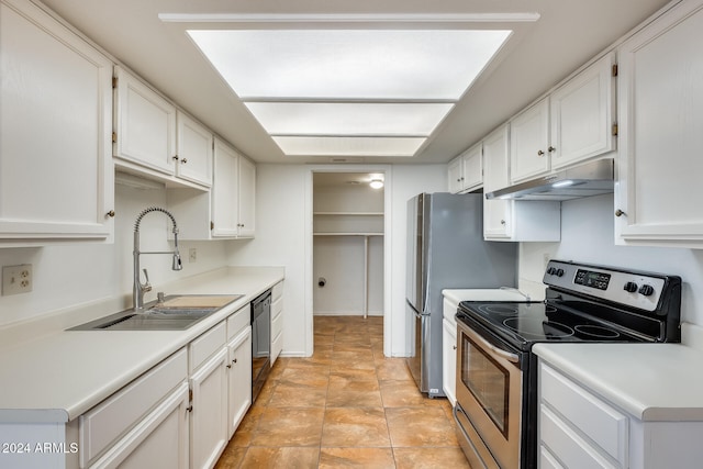 kitchen with stainless steel electric stove, white cabinets, and sink