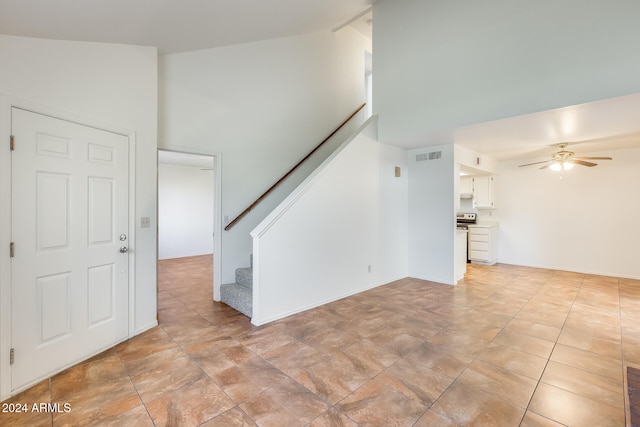 unfurnished living room with ceiling fan and lofted ceiling