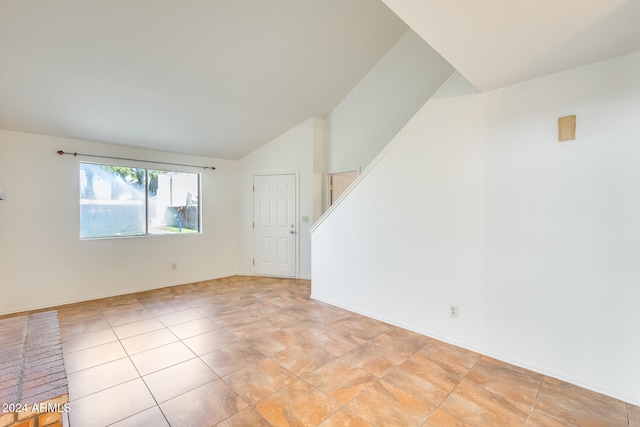 spare room with vaulted ceiling