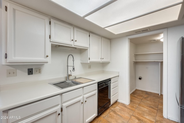 kitchen with white cabinets, black dishwasher, and sink