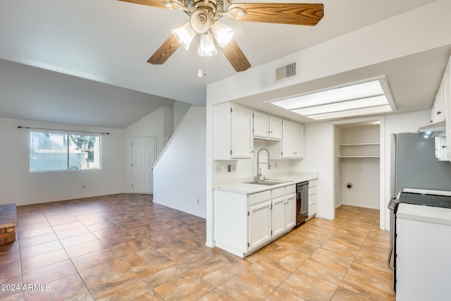 kitchen with stove, white cabinets, sink, dishwasher, and lofted ceiling