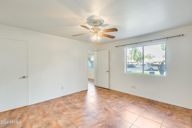 spare room with ceiling fan