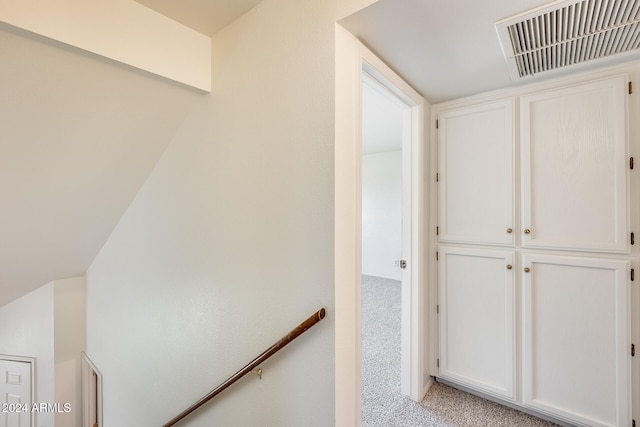 hallway featuring light carpet