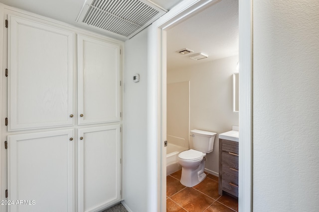 bathroom featuring a shower, tile patterned floors, vanity, and toilet