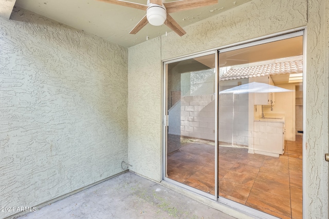 doorway to property featuring ceiling fan