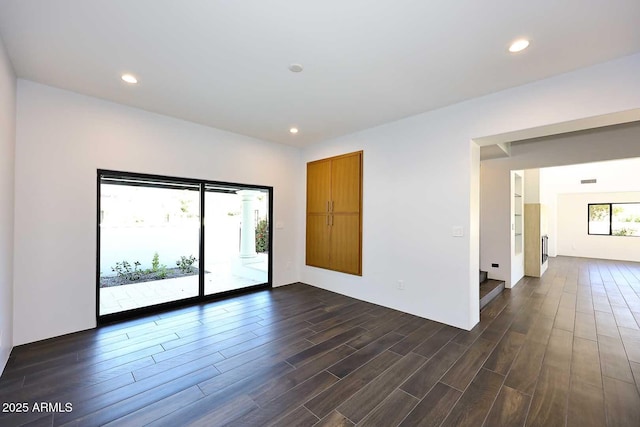 empty room with dark hardwood / wood-style flooring