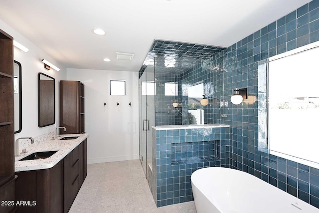 bathroom with plus walk in shower, tile walls, tile patterned floors, and vanity