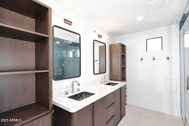 bathroom with vanity, a shower with shower door, and tile patterned floors