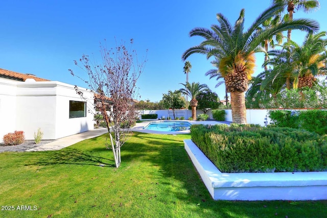 view of yard with a fenced in pool