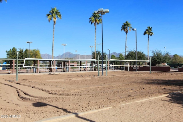 view of community with a mountain view and volleyball court