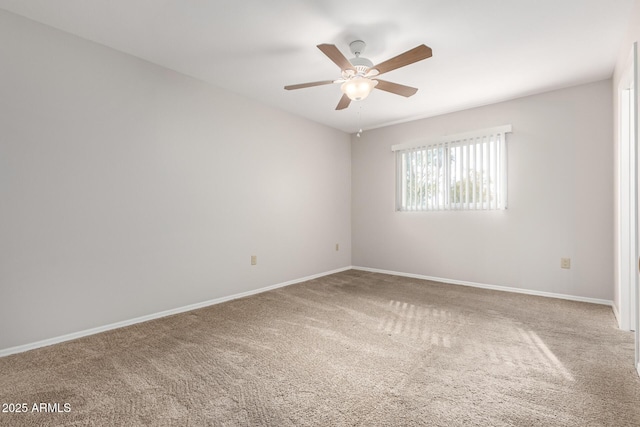 empty room featuring ceiling fan and carpet