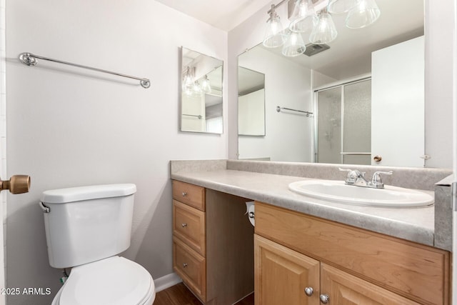 bathroom with vanity, toilet, and walk in shower