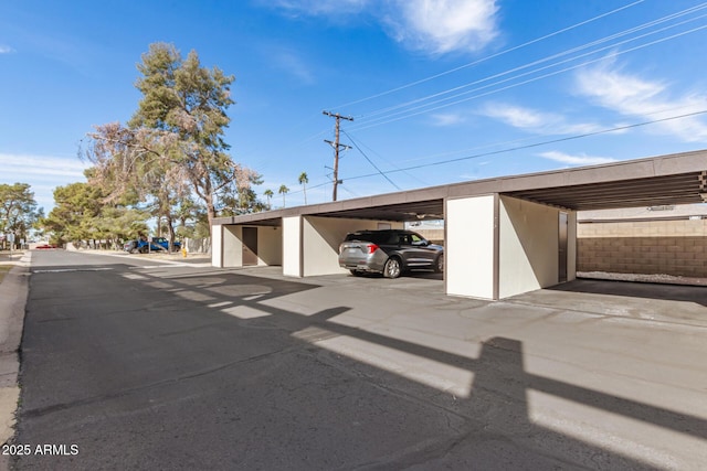 view of parking / parking lot featuring a carport