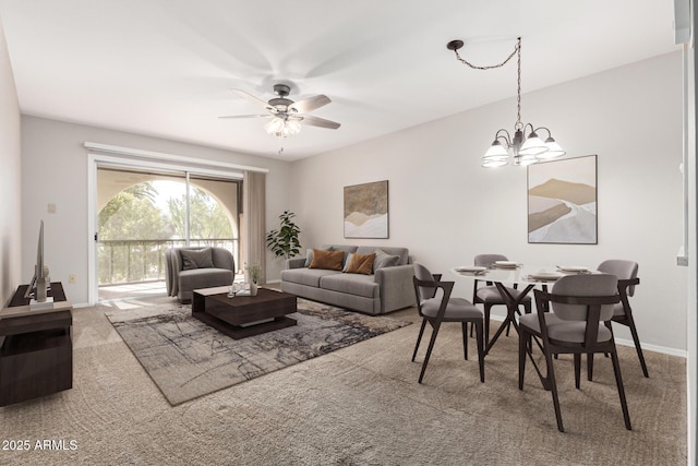 living room with ceiling fan with notable chandelier and carpet flooring