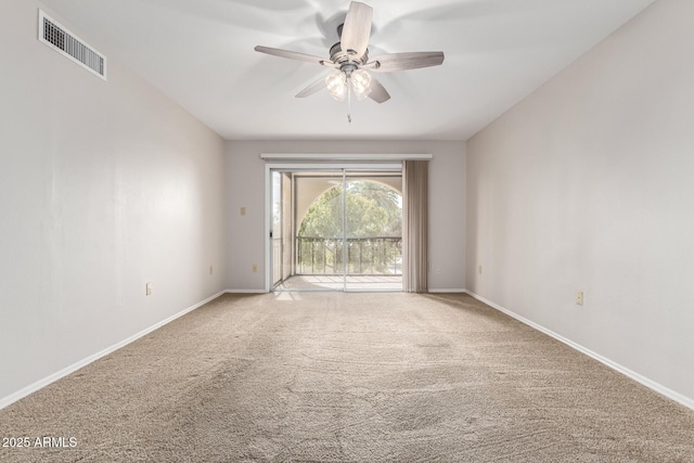 carpeted spare room featuring ceiling fan