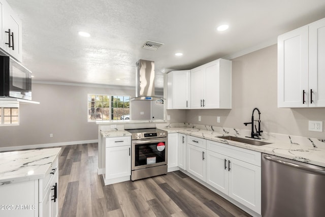 3249 E Nisbet Rd, Phoenix, AZ 85032 - kitchen with dark wood-type flooring, a peninsula, island exhaust hood, stainless steel appliances, and a sink