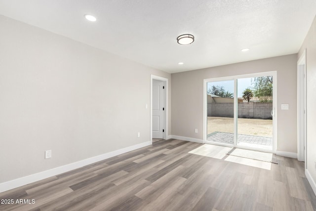 3249 E Nisbet Rd, Phoenix, AZ 85032 - empty room with recessed lighting, a textured ceiling, light wood-style floors, and baseboards